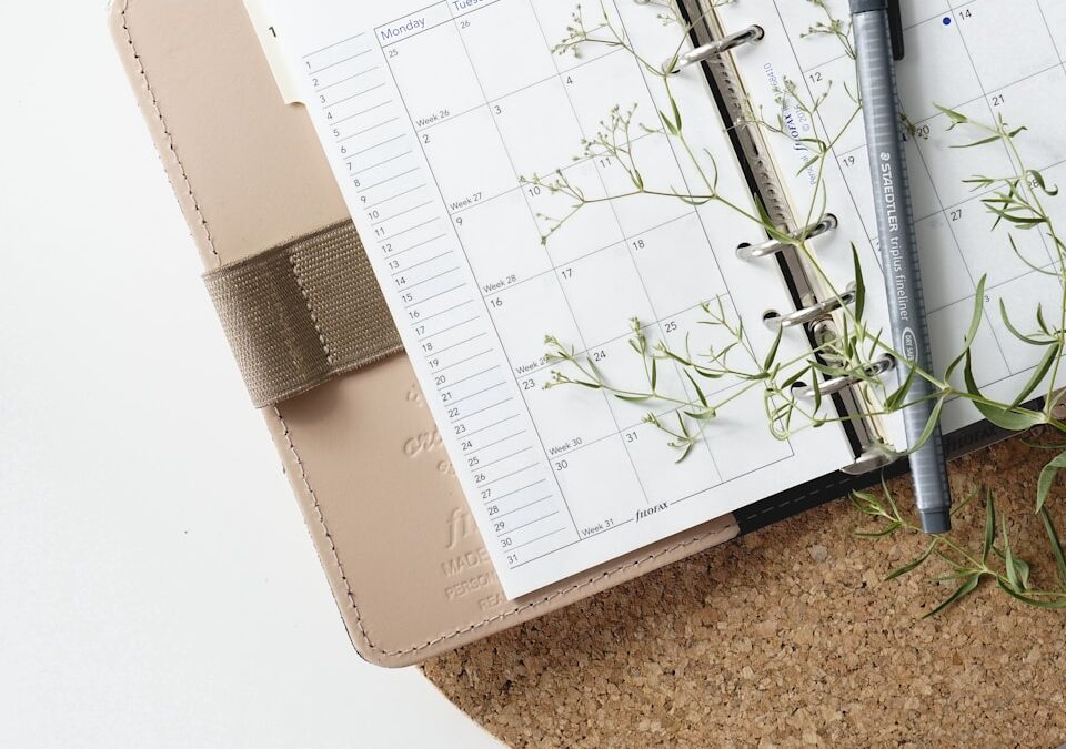 grey and black pen on calendar book